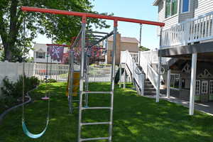 View of jungle gym featuring a wooden deck