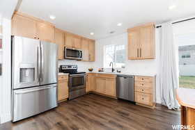 Kitchen featuring light brown cabinetry, appliances with stainless steel finishes, light countertops, and recessed lighting