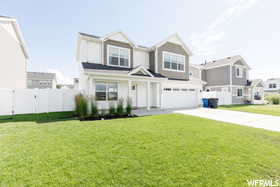 View of front of house with an attached garage, concrete driveway, and a residential view