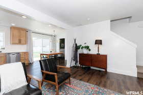 Living room featuring wood finished floors, baseboards, and recessed lighting