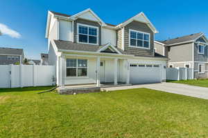 View of front of property with covered porch, driveway, and an attached garage