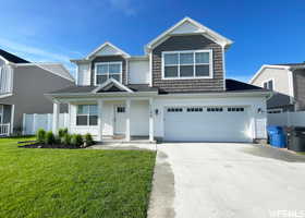 View of front facade with driveway, a garage, and covered porch
