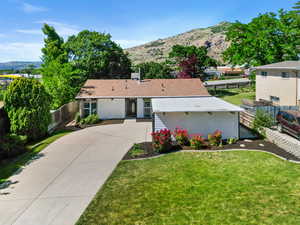 View of front of property featuring a mountain view and concrete driveway