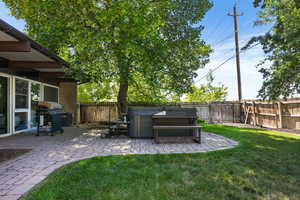 View of yard featuring a patio area and a hot tub