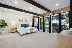 Carpeted bedroom with beam ceiling, recessed lighting, baseboards, and floor to ceiling windows