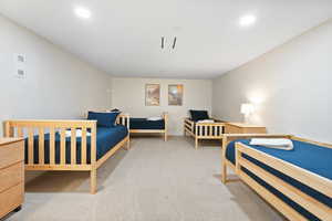 Carpeted bedroom with recessed lighting and baseboards