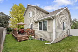 Back of house with a wooden deck and a shingled roof