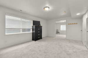 Unfurnished bedroom featuring light carpet and baseboards