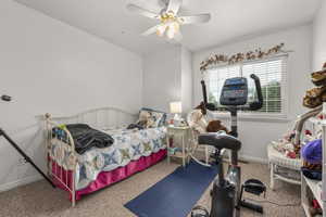 Bedroom featuring carpet, baseboards, and ceiling fan