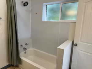 Bathroom featuring shower / bath combination with curtain