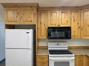 Kitchen featuring white appliances and light countertops