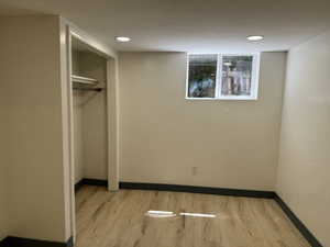 Unfurnished bedroom featuring light wood finished floors, baseboards, a closet, and recessed lighting