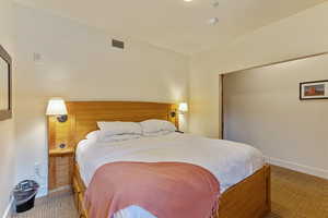 Carpeted bedroom with baseboards