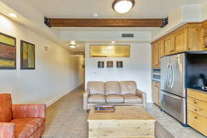 Living room featuring beam ceiling and recessed lighting
