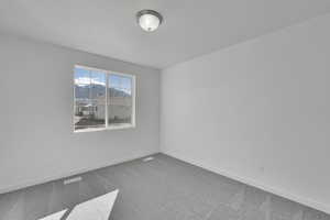 Empty room with carpet and baseboards