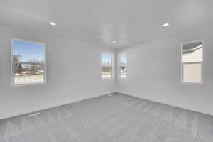 Spare room with carpet flooring, baseboards, and recessed lighting