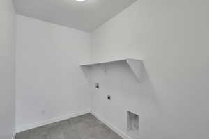 Washroom featuring hookup for a washing machine, hookup for an electric dryer, and baseboards