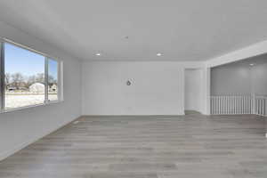 Empty room featuring recessed lighting, light wood-style flooring, and baseboards