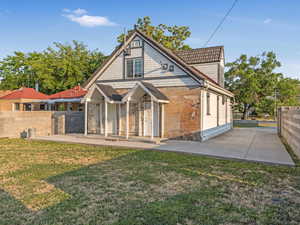 Back of house with a patio and brick siding