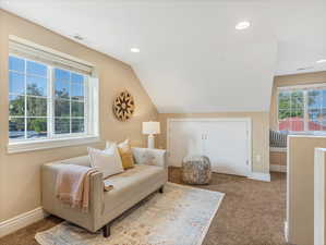 Living area featuring carpet flooring, recessed lighting, baseboards, and vaulted ceiling