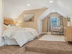 Carpeted bedroom featuring vaulted ceiling, recessed lighting, cooling unit, and baseboards