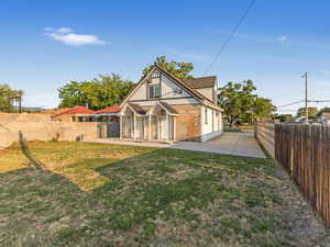 Back of house featuring a patio and brick siding