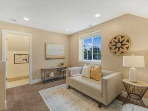 Tiled living area featuring carpet floors, baseboards, and recessed lighting