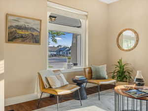 Living area with wood finished floors and baseboards