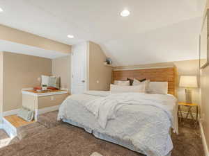 Carpeted bedroom featuring vaulted ceiling, baseboards, and recessed lighting