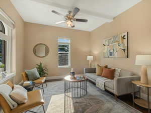Living room with wood finished floors, baseboards, and ceiling fan