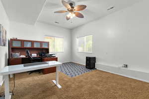 Home office with carpet flooring, ceiling fan, and baseboards