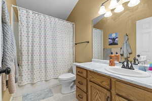 Bathroom featuring vanity, toilet, and tile patterned floors