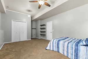 Bedroom featuring carpet, baseboards, ceiling fan, and a closet