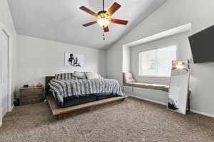 Bedroom featuring vaulted ceiling, carpet, a ceiling fan, and baseboards