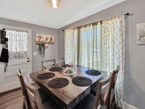 Dining space with plenty of natural light and wood finished floors