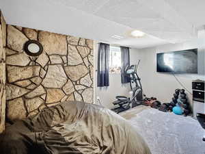 Bedroom featuring carpet floors and a textured ceiling