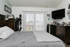 Bedroom featuring lofted ceiling