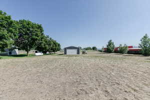 View of yard with a detached garage and an outdoor structure