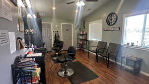 Home office featuring lofted ceiling, a ceiling fan, and wood finished floors