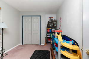 Rec room featuring carpet flooring and baseboards