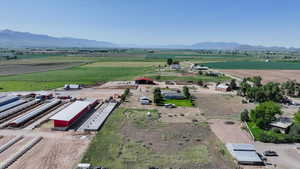 Aerial view of sparsely populated area with mountains and rows of crops