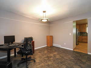 Office featuring baseboards and a textured ceiling