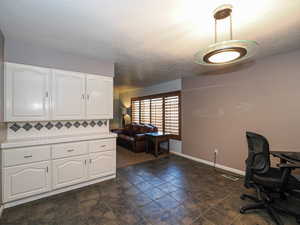 Office space featuring baseboards and a textured ceiling