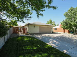 View of side of home featuring a garage and driveway