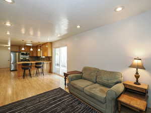 Living room featuring light wood finished floors and recessed lighting