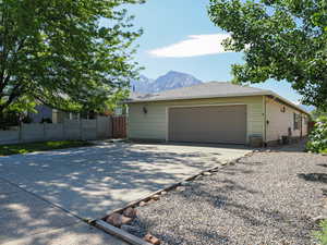 View of home's exterior with a garage, a mountain view, and driveway