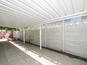Fenced backyard with a patio