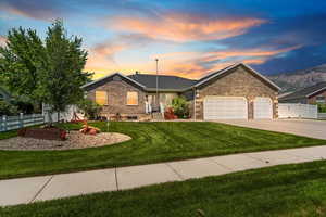 Single story home featuring a garage and driveway