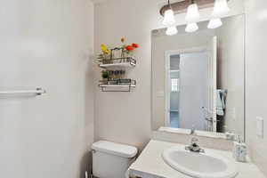 Half bathroom with toilet and vanity