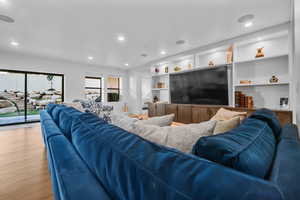Living area featuring light wood-style floors and recessed lighting
